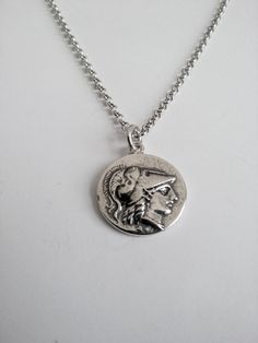 Varouxi Pendant Goddess Athena Silver 925 a very nice pendant in silver 925 a souvenir from ancient Greece accompanied by a silver chain 925 length 45cm Diameter coin:18mm Weight coin:5,0gr total weight:9,2gr Metal:silver 925 MACEDONIAN KINGS. Alexander the Great. 323-317 B.C. E. Head of Goddess Athena O.The Goddess Nike with laurel wreath All creations are specially designed, hand cast of solid silver, and individually polished Black oxidised background to enhance ( coin ) symbols Made entirely Nickel-free Sterling Silver Round Medallion Necklace, Nickel Free Sterling Silver Round Medallion Necklace, Handmade Silver Coin Necklace, Handmade Silver Round Coin Necklace, Nickel-free Sterling Silver Round Coin Necklace, Ancient Style Round Pendant Coin Necklace, Ancient Style Coin Necklace With Round Pendant, Handmade Silver Coin Medallion Necklace, Symbolic White Gold Necklace With Coin Pendant