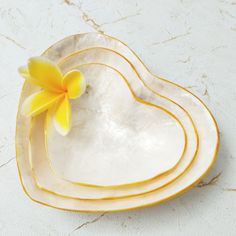 three heart shaped plates with yellow flowers on them