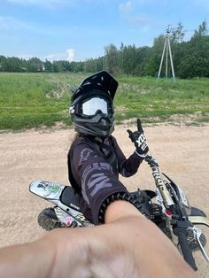 a person riding a motorcycle on top of a dirt field