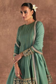 Moss green anarkali edged with kinari and embellished with border. Comes with irisbud foil printed sharara edged with kinari and a printed dupatta.
Components: 3
Pattern: Foil Printed, Embroidered
Type Of Work: Irisbud
Neckline: Round
Sleeve Type: Full
Fabric: Anarkali and Sharara- Raw Silk, Dupatta- Organza
Color: Green
Other Details: 
Disclaimer: The actual print-placement and colour of the product may vary slightly from the image shown.
Occasion: Sangeet - Aza Fashions Luxury Anarkali Slub Silk Sharara, Luxury Raw Silk Anarkali Sharara, Luxury Green Cotton Silk Sharara, Luxury Green Sharara With Bandhani Print, Green Raw Silk Anarkali Set For Reception, Designer Green Palazzo Set With Dupatta, Green Palazzo Set With Dupatta, Green Anarkali Palazzo Set With Zari Work, Designer Anarkali Palazzo Set In Green