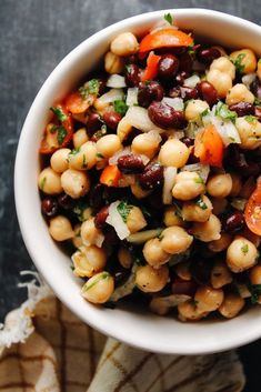 a white bowl filled with beans and carrots