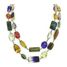 This is a wonderful 14k yellow gold multi color semi precious stones necklace. The necklace features oval, pear, emerald, round, trapezoid, marquise and cushion cut of amethyst, citrine, green tourmaline, blue topaz and quartz. The approximate weight of this lovely stones is a total of 550.00ct. The necklace measures 19mm in width at the widest base and 39 1/4 inches in length. The necklace weighs 125 grams. Luxury Multicolor Amulet Necklace, Luxury Multi-stone Jewelry For Celebration, Stones Necklace, Unusual Jewelry, Semi Precious Stones, Green Tourmaline, Link Necklace, Cushion Cut, Stone Necklace