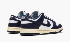 The Nike Dunk Low “Vintage Navy” is a classic two-tone, white-and-navy colorway for the retro basketball shoe with a decidedly throwback vibe.  The “Vintage Navy” edition of the Dunk Low calls back to original styles found in the “Be True to Your School” pack of college basketball-inspired colorways from 1985.  The shoe’s upper features a white leather base with contrasting Vintage Navy-colored leather overlays and Swoosh branding.  White “Nike” branding is embroidered on the heel, and navy “Nik Nike Dunk Low Vintage Navy, Nike Heels, Low Dunks, Sneakers Box, Kobe Shoes, Navy Blue Shoes, Shoe Wishlist, Sneaker Release, Nike Vintage