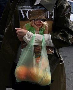 a woman holding a plastic bag with an instagram message on the front and bottom