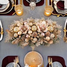 the table is set with silver and gold plates