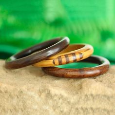 For a chic addition to your wardrobe, this set of three bangle bracelets is presented by Vipin in India. He works with local artisans, who hand-carve each bangle from mango wood. Two bracelets feature a solid hue in dark brown while the third displays a light brown hue with striped patterns. This set is perfect for wearing together or sharing with friends. Yard Sale Finds, Wooden Bracelet, India Jewelry, Local Artisans, Jewelry Packaging, Mango Wood, Jewelry Gift Box, Bracelet Sizes, Light Brown