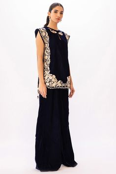 Dress up at any evening soiree with this embroidered top, cut from lustrous velvet with fish motifs tracing the neckline. Wear it with matching velvet palazzo. Elegant Embroidered Top With Traditional Drape, Elegant Dress With Embroidered Neckline And Traditional Drape, Elegant Embroidered Top With Traditional Drape For Festive Occasions, Festive Party Sets With Embroidered Neckline, Sequin Palazzo Saree Set For Evening, Evening Palazzo Saree Set With Sequins, Elegant Embroidered Top For Designer Wear And Festive Occasions, Elegant Embroidered Top For Festive Designer Wear, Elegant Embroidered Top With Zari Work And Traditional Drape