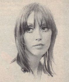 a black and white photo of a woman with bangs