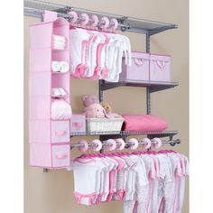 the baby's closet is organized with pink and white items