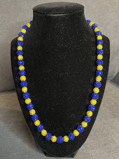 Grab this custom Blue & Yellow Beaded Baseball Necklace Blinged Out with rhinestone beads!  w/ magnetic clasp for ease and comfort. 20in Elevate your style AND your game with our vibrant, handcrafted beaded necklace.   Look Good, Feel Good, Feel Good Play Good! BLING BLING ⚾️🏈⚽️🏀⚾️️ 📿 Baseball Football Soccer Softball Basketball 🌟 Features: Blinging & Bursting with Co:lor: A symphony of dazzling, handpicked beads in every hue imaginable - from vivid orange to black! 🌟 Unique Design 💎 Quality Matters: Thick Elastic band and magnetic clasps ensure durability and long-lasting wear. 🌟 Versatile Wear: Perfect for all sports fields😎, beach days, date nights, or simply adding a pop of personality to your everyday look. A conversation piece. 📸 Instagram-Ready: Be prepared for compliments Gift Rhinestone Beaded Necklaces, Gift Beaded Rhinestone Necklace With Round Beads, Adjustable Bling Beaded Necklace For Gift, Baseball Necklace, Look Good Feel Good, Bead Chain, Rhinestone Bead, Rhinestone Necklace, Magnetic Clasp