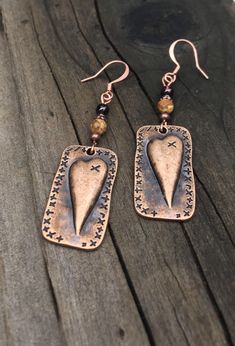 Unique copper heart earrings with Garnet and picture jasper gemstones. You will love these antique copper steam punk heart earrings! Garnet is the stone of love, and it is the perfect complement to the picture jasper stone. These earrings are 2 inches long and 5/8 of an inch wide. They are slightly heavier than most of my other earrings, but not too heavy. Weight is 3.8 grams. The French ear wires are solid copper. All my jewelry comes gift boxed with a custom Shelly Mariposa Design butterfly ca Handmade Bronze Jewelry For Valentine's Day, Bohemian Metal Heart Earrings As Gift, Heart-shaped Gold Jewelry In Copper, Bohemian Style Heart Earrings As A Gift, Handmade Vintage Rust Earrings, Handmade Rust Vintage Earrings, Brown Steampunk Jewelry Gift, Steampunk Brown Jewelry For Gift, Handmade Vintage Rust-colored Earrings