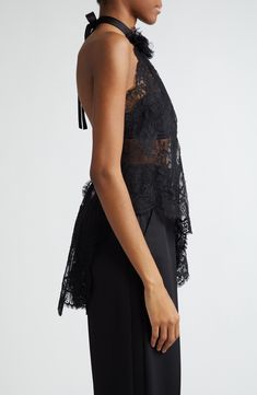 The Italian house's obsession with lace brings dark romance to your collection with a sheer Chantilly top cut with a diagonally slanted, asymmetric hem. A back-baring halter neck centered with a voluminous rosette appliqué brings drama to your look, while a cascading bow at the nape adds a coquettish touch. Adjustable back tie closure Halter neck Sheer; base layer shown not included 68% cotton, 22% nylon, 10% silk Dry clean Made in Italy Designer Clothing Sheer Sleeveless Lace Top For Evening, Luxury Sheer Tops For Party, Elegant Fitted Top With Lace Closure, Elegant Fitted Tops With Lace Closure, Luxury Sheer Tops For Evening, Luxury Sheer Evening Tops, Elegant Lace Tops With Lace Closure, Chic Sheer Lace Top For Evening, Chic Sheer Lace Top For Formal Occasions