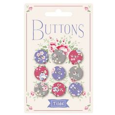 buttons with flowers and leaves on them in pink, blue, purple and white colors