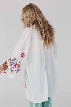 Elevate all of your favorite boho outfits with the Waikiki Beach Embroidered Kimono! This kimono is a true show - stopper, sure to get compliments when worn because it features Lightweight and flowy woven fabric with a relaxed and loose kimono silhouette Classic open front closure allows you to show off your favorite outfits underneath Long and loose kimono sleeves Stunning embroidered floral details throughout Classic boho outfit pair with: High Neck Racerack Brami, Billy Corduroy Pants, Over T Embroidered Kimono For Spring Festival, Spring Folk Kimono With Floral Embroidery, Summer Long Sleeve Top With Floral Embroidery, Spring Folk Style Embroidered Kimono, Summer Folk Style Embroidered Kimono, Summer Embroidered Folk Kimono, Embroidered Folk Kimono For Summer, Embroidered V-neck Kimono For Spring, Bohemian Summer Kimono With Floral Embroidery