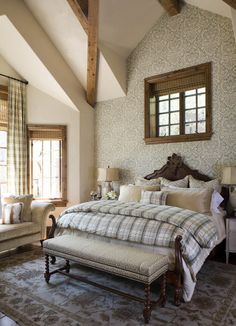 a bedroom with a large bed sitting next to a window in the middle of it