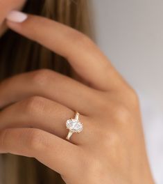 a woman's hand with a diamond ring on it