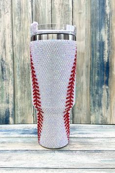 the red and white baseball tumbler is decorated with crystals