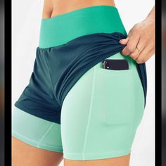 Nwt Fabletics Olesia Turquoise Teal Sea Green Layered Shorts. Light Green Layer Are Compression Shorts, Dark Teal Layer Is Like A Windbreaker Material. Dry Wicking. Phone Pocket. Color Blocking. Smoke Free, Pet Friendly Home Green Activewear For Gym With Elastic Waistband, Green Activewear With Elastic Waistband For Gym, Sporty Green Yoga Bottoms, Green Activewear With Elastic Waistband For Training, Green Sports Activewear With Elastic Waistband, Green Sportswear Yoga Shorts, Green Activewear With Elastic Waistband For Sports, Green Sportswear Shorts For Yoga, Green Moisture-wicking Workout Bottoms