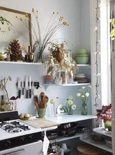 a kitchen filled with lots of pots and pans next to a stove top oven