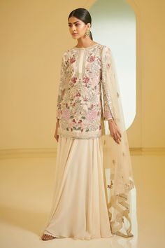 Ivory straight short kurta with floral motifs, resham embroidery and sequin, cutdana-pearl work. Comes with embellished sharara and dupatta.
Component: 3
Embroidered
Neckline: Round
Sleeve Length: Long
Color: White
Concealed placket - Aza Fashions Varun Bahl, Embroidered Sharara, Kurta Sharara Set, Kurta Sharara, Kurta Style, White Kurta, Pink Embroidery, Traditional Indian Outfits, Sharara Set