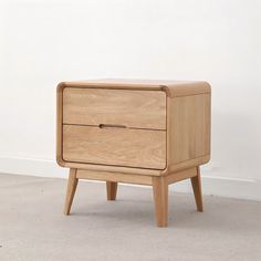 a wooden nightstand with two drawers on one side and an open drawer on the other