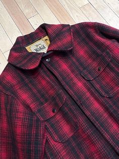 "AMAZING Vintage WOOLRICH Plaid HUNTING Men's Coat, Size 42 Are you looking for a coat with a TON of pockets? Do you need a coat for hunting? Or maybe you just need an extremely warm coat! Well don't let this vintage Woolrich beauty pass you by. Although it's definitely seen some love, this 1960's-1970's Woolrich piece is sure to impress all your Woolrich collecting buddies! Era: 1960's-1970's Label / Brand: Woolrich Features: BIG Rifle Pocket at back! Condition / Wear / Flaws: Some tears and a homemade pocket, overall not bad condition, still very much wearable. Made in: U.S.A Size: 42 Material:  - Shell: 100% Wool - Lining: 100% Cotton Measurements laying flat: - Shoulders: 36\" - Chest: 42\" - Sleeve: 23\" Across from Shoulder to Armpit - Cuff: 12\" - Length: 30\" Across - Collar: 10\" Plaid Outerwear With Button Closure And Spread Collar, Red Winter Outerwear With Welt Pockets, Long Sleeve Outerwear With Pockets For Hunting, Classic Plaid Outerwear With Pockets, Plaid Outerwear With Pockets And Spread Collar, Fall Hunting Outerwear With Patch Pockets, Classic Plaid Outerwear With Spread Collar, Wool Outerwear With Patch Pockets For Outdoor, Long Sleeve Hunting Outerwear With Flap Pockets