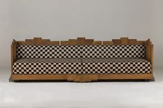 a black and white checkered couch sitting on top of a wooden frame