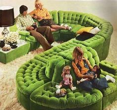 a group of people sitting on top of green couches