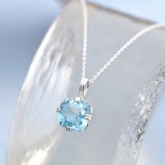 Topaz Solitaire Pendant - A stone of delightful light Swiss blue colour and clarity. It is set in a sturdy sterling silver bail with sterling silver necklace. chain. * Stone: Swiss Blue Topaz, 12mm cushion cut * Sterling silver * December birthstone - December Birthday pendant * Boxed, ready for gifting * Supplied with sterling silver diamond cut adjustable chain 18-20"/45-50cm You will receive a pendant like the one in the photograph, colour may vary slightly We have one for immediate dispatch. White Gold Aquamarine Gemstone Necklace, Sapphire Gemstone Birthstone Necklace In Sterling Silver, Sterling Silver Sapphire Birthstone Necklace, Sapphire Birthstone Necklace In Sterling Silver, Light Blue Pendant Necklace Fine Jewelry, Fine Jewelry Light Blue Pendant Necklace, Light Blue Round Birthstone Jewelry, White Gold Aquamarine Necklace Gift, White Gold Aquamarine Necklace For Gift