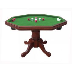 a wooden table with green cloth on top and four red dices in the middle