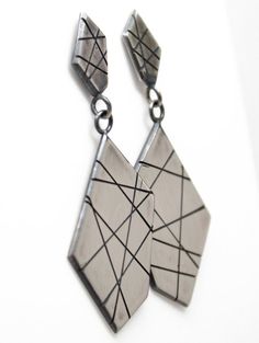 A modern play on sterling silver dangle earrings.  These earrings are hand made from recycled sterling silver sheet.  The design is sawed by hand and polished to a matte finish.  The silver has been oxidized to add depth and beauty.  Solid 925 Sterling SilverAbout 2" L x .75" WPost style with deluxe Luxlock Backs-Safe, Secure, ComfortableArtisan made in TexasThe earrings will arrive thoughtfully packaged in a signature jewelry box. Click here to see all of my earrings:  https://www.etsy.com/shop Modern Handmade Long Drop Linear Earrings, Modern Sterling Silver Nickel-free Linear Earrings, Modern Nickel-free Sterling Silver Linear Earrings, Silver Geometric Pierced Earrings, Modern Geometric Sterling Silver Earrings, Sterling Silver Geometric Earrings, Handmade Silver Geometric Earrings, Modern Silver Linear Earrings As Gift, Handmade Sterling Silver Geometric Jewelry