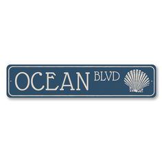 the ocean blvd sign is blue and white with an image of a shell on it