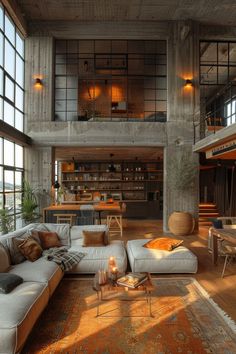 a living room filled with lots of furniture next to tall windows on top of a wooden floor