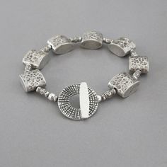 "Beautiful handmade artisan fine silver beads encircle your wrist and close with a handmade sterling silver toggle clasp. All metal is solid .925 - .970 sterling and fine silver. Silver Box beads - 1/2\" long Toggle Clasp - slightly over 3/4\" in diameter Length - approx. 7 1/8\" long View more items in my shop here: http://www.etsy.com/shop/DJStrang?ref=si_shop Item ships insured 1st Class Mail within 48 hours of cleared payment, excluding weekends and holidays." Adjustable Hand-strung Fusion Jewelry, Adjustable Sterling Silver Fusion Bracelets, Adjustable Sterling Silver Beaded Fusion Bracelets, Sterling Silver Fusion Bracelets, Adjustable Silver Beads Fusion Jewelry, Adjustable Fusion Style Silver Beaded Jewelry, Adjustable Silver Beaded Fusion Bracelet, Artisan Sterling Silver Jewelry With Spacer Beads, Artisan Jewelry With Spacer Beads In Sterling Silver