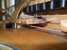 a close up view of the strings on a guitar's body and back end