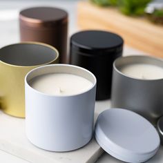 several different types of candles sitting on a table