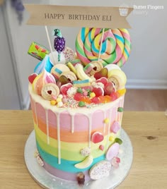 a birthday cake decorated with candies and lollipops