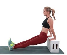 a woman in red leggings and black top doing an exercise on a white box