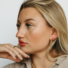 If you’re looking for a bold, statement-making earring that won’t break the bank, then this is it. With its 18k gold-filled Cuban link chain and drop style stud design, our Tatum Chain Link Earring is the perfect way to add some sass and glamor to your outfit. Wear them with jeans and t-shirt or dress them up with a cocktail dress and heels-no matter how you wear them, they’ll be sure to turn heads! Yellow Gold Chain Earrings For Everyday, Everyday Yellow Gold Chain Earrings, Trendy Drop Earrings With Chain Detail, Minimalist Gold Chain Earrings, Trendy Chain Link Earrings, Chic Chain Link Earrings, Modern Gold Chain Link Earrings, Adjustable Chain 14k Gold Filled Earrings, Dangle Hoop Earrings With Cable Chain