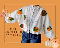 a child's cardigan with pumpkins on it