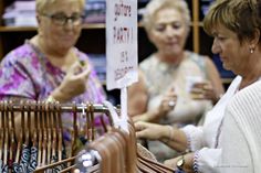 three women looking at items in a store