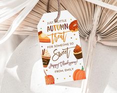 an autumn treat tag hanging from a palm tree