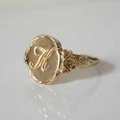 This vintage style signet ring is inspired by 17th-century Italian Baroque architecture, featuring beautiful little fluorishes all around the center which displays your personal monogram or initials. This ring can be customized with any letter or word (provided it fits) and is made in solid gold. This ring can be made for men or women and in your preferred size or color of gold. A phrase or letter may be written on the inside, too! All designs are modelled and sent to you for approval before cas Victorian Engraved Signet Promise Ring, Victorian Yellow Gold Rings With Engraving Option, Victorian Style Yellow Gold Rings With Engraving Option, Victorian Initials Signet Ring For Anniversary, Antique Signet Ring With Initials For Formal Events, Victorian Oval Rings With Engraving Option, Victorian Engraved Yellow Gold Ring With Intaglio, Vintage Yellow Gold Engraved Initial Ring, Victorian Yellow Gold Engraved Ring With Intaglio