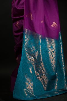 Get ready to turn heads with this stunning silk saree! The beautiful purple and azure blue color combination of this Silk saree will make a strong statement no matter where you go. Intricate gold embroidery work along the pallu adds a bit of traditional flair that makes this saree perfect for special occasions. Whether you're attending a wedding or hitting up an office party, this classic yet eye-catching look is sure to make your mark on any setting. Plus, you'll stay comfortable since the lush fabric of silk wraps around you like second skin. Make an unforgettable impression with this regal and unique ensemble! Blue Katan Silk Pre-draped Saree With Zari Work, Blue Katan Silk Pre-draped Saree, Blue Paithani Silk Pre-draped Saree With Traditional Drape, Bollywood Style Purple Handloom Pre-draped Saree, Traditional Purple Tissue Silk Pre-draped Saree, Traditional Purple Pre-draped Saree, Purple Art Silk Pre-draped Saree With Self Design, Blue Chanderi Pre-draped Saree With Motifs, Purple Katan Silk Pre-draped Saree With Zari Work