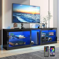 an entertainment center with blue lights and remote controls