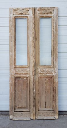 an old pair of double doors on the side of a building