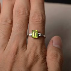 This is a gorgeous handmade creation. Its beauty is its simplicity & Elegance. The 6*8 mm emerald shape faceted natural peridot is crafted in solid sterling silver and with rhodium plated. All item is sent in a beautiful gift box If you have any idea of design your ring,pls contact me directly. You can realize more lovely stuff clicking the link https://www.etsy.com/shop/knightjewelry?refshopsection_shophome_leftnav Please leave the correct address and you phone number for delivering success Emerald Cut Peridot Ring For May Birthstone, Emerald Cut Peridot Gemstone Jewelry, Green Citrine Rings With Accent Stones, Green Citrine Gemstone Rings, Emerald Cut Peridot Birthstone Ring, Green Emerald Cut Crystal Birthstone Ring, Emerald Cut Green Crystal Birthstone Ring, Emerald Cut Green Gemstones With Accent Stones, Emerald Cut Peridot Ring Gift