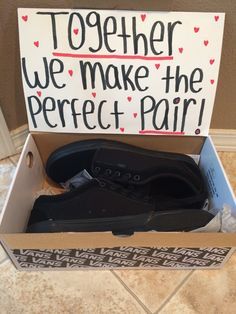 a pair of black shoes in a box that says together we make the perfect pair