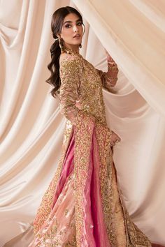 Pink Long Gown Lehenga Pakistani Wedding Dresses is a garment that has a french tissue satin bridal gown, lehenga, and dupatta with a heavily embellished worked border and a lighter border on the other three sides. This is an exquisite pink Satin gown with lace sleeves and a net dupatta with scalloped borders. Pink Lehenga Gown: This alluring outfit is surely any girl’s dream. The pink front open gown is a magnificent choice which is ornamented with silver embroidery that wins everyone’s hearts Eid Ceremony Choli With Dabka Work, Gold Dabka Dress For Reception, Gold Dabka Reception Dress, Floor-length Choli With Dabka Work For Ceremony, Anarkali Gown With Traditional Drape For Weddings, Organza Sharara With Dabka For Reception, Floor-length Raw Silk Sharara For Wedding, Pink Gown With Dabka For Reception, Wedding Raw Silk Floor-length Sharara