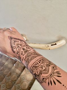 a person's arm with a tattoo on it and a banana in the background